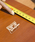 Frosted Acrylic Cabinet Hinge With Pre Drilled Holes for easy install, shown with measuring tape and pencil on wood surface