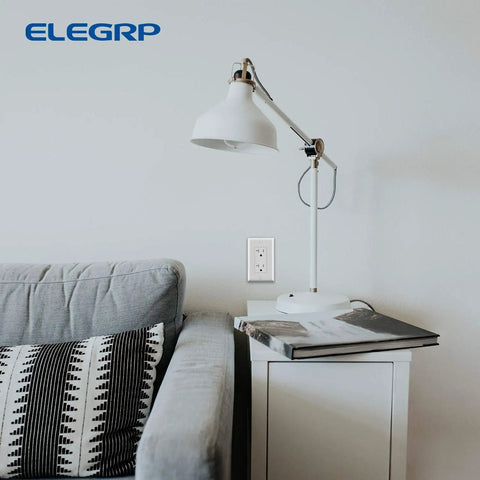 Living room with Durable No-Fuss Decorative Receptacle Wall Plate 1-Gang Standard Size Decorator Covers on wall next to lamp and sofa