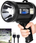 Rechargeable Spotlight With 2,000,000 Lumens in hand, USB charging cables, ultra bright beam on trees, hunting flashlight.