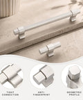 10 Pack Brushed Nickel Single Hole Kitchen Cabinet Knobs Fingerprint Resistant Coating Keeps Smudges at Bay Silky Smooth Anodized Aluminum Rust Free 2.36 Inch geometric cabinet hardware on a countertop.