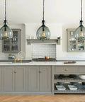 Modern kitchen with three Ginormous Mouth Blown Glass Pendant Light Fixtures, 13 Inch Clear Globe Shade, above a large island.
