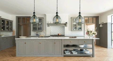 Modern kitchen with three Ginormous Mouth Blown Glass Pendant Light Fixtures, 13 Inch Clear Globe Shade, above a large island.