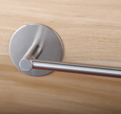 Close-up of 16 Inch Stainless Steel Towel Bar With 3M Self Adhesive Wall Mount No Drill Brushed Nickel on wooden surface.