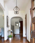 Cozy Rustic Farmhouse Wood Chandelier Pendant Light for Dining Room and Kitchen in open entryway with wooden floors.