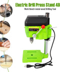 Powerful 480W Mini Bench Drill Press Machine With Dual Speed Settings Up To 11000 RPM For Drilling Wood Hard Plastic Aluminum And Thin Metal In Home Workshop Projects with green stand and drill bit.