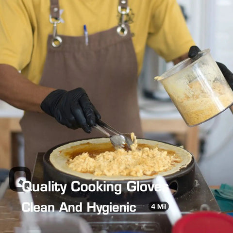 Chef wearing Textured Nitrile Exam Gloves Latex Free And Powder Free 5 Mil Non Sterile Disposable Gloves adding cheese to pan.