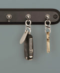 Stainless Steel S Biner MicroLock locking key holder set with dual gates hanging on rack, holding keys and key fob