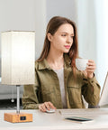 Set Of 2 Wood Table Lamps For Bedroom With 3 Color Modes Warm White Soft White Daylight White Pull Chain Nightstand Lamps With AC Outlets Compact Bedside Lights With 2 Bulbs For Living Room Kids Room Office Decor shown on office desk with woman working on computer.