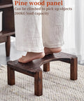 Person standing on pine wood step stool with high load capacity for reaching items