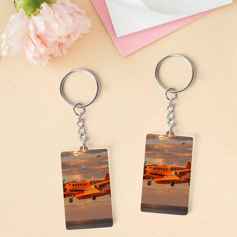 Orange Daylight Aircraft Keychain Set With Personalized Acrylic Keyrings, Chains And Jump Rings on pink and beige background