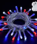 Coiled string of red, white, and blue LED lights with timer box. Red White and Blue Battery Operated Outdoor Lights With Timer About Ten Feet Long 30 LED Waterproof For Fourth Of July Independence Day Decorations Garland Patio Or Garden Party Decor Easy Setup.