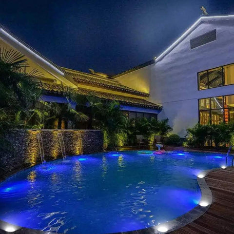 Low Voltage Landscape Well Lights 12W 12 To 24V AC DC In Ground Garden Lights illuminating a poolside at night