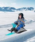 Child riding Steerable Ski Sled With Steering Wheel And Twin Brakes, Heavy Duty Go Kart Snow Scooter For Kids And Grownups, 220 Lbs Weight Capacity, Winter Outdoor Fun On Snow, Pull Rope, Green on snowy landscape