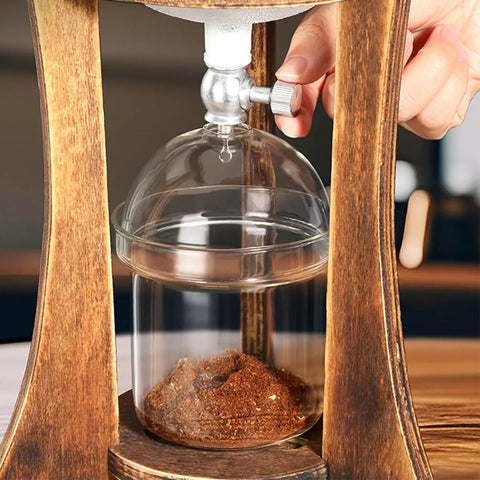 Top Shelf Portable Cold Brew Drip Tower And Iced Coffee Maker With Dual Adjustable High Borosilicate Glass Valves, close-up of glass container with coffee grounds.