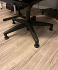 No Slip Bell Glides For Office Chairs And Stools Replacement High Profile Stationary Castor Wheels With Stick On Felt Pads on a chair on wood floor.