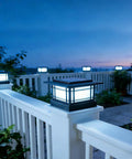 Boss Tier 4X4 Solar Post Cap Lights With Slick Black Shield And Dual Tone LED Panels illuminating a garden deck at dusk.