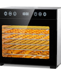 Top Shelf Eight Tray Stainless Steel Food Dehydrator With No Sweat Temperature Tuning Bright Interior Light showing sliced fruits and herbs drying.