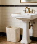 Natural Travertine Textures Tiny Trash Can 1.8 Gallon Bathroom Space Saver Garbage Bin beside white pedestal sink