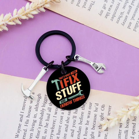 Keychain Gift For Men I Fix Stuff And I Know Things Ideal Dad Gift For Mechanic Handyman on book page with wrench charm