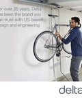 Person using Michelangelo Gravity Two Bike Storage Rack No Drill Wall Lean Vertical Bike Holder For Road, Mountain, And Hybrid Bicycles Holds Up To 80 Lbs With Fully Adjustable, Gravity-Driven Design For Easy Space-Saving Garage Storage