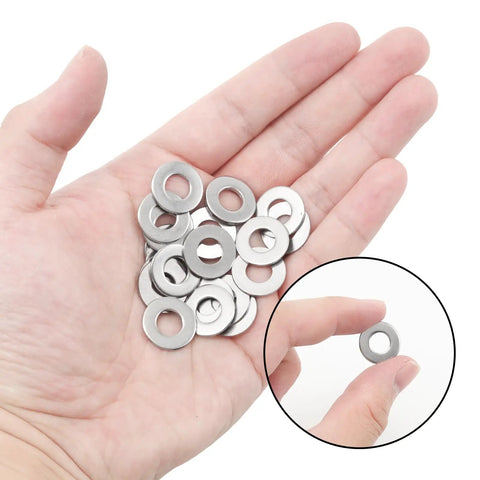 Close-up of hand holding Heavy Duty Flat Washers 100 Pack One Quarter Inch Inside Diameter Five Eighths Inch Outside Diameter Point Zero Four Inch Thick Stainless Steel 304 Fender Washers Tough As Nails For Screws Bolts Rust Resistant DIY Projects