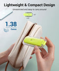 Green Go-To Clip On Book Light For Reading At Night with amber glow shown next to a small pouch demonstrating compact size.