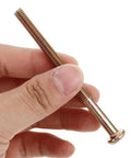 Hand holding copper alloy bolt from Bulletproof Furniture Connector Bolts And Nuts Kit With Hex Socket Heads Copper Alloy Fasteners For Headboards And Crib Repair Heavy Duty Wood Screws Set For Long Lasting Strength And Easy Assembly