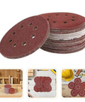 Top Notch 150 Piece Inch Sanding Discs With Hook And Loop Fastener For Wood Metal stacked in a pile with 8-hole design.
