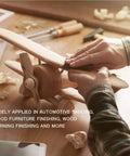 Hands using 24 Pack Sandpaper Variety Kit With 12 Grits From 120 To 3000 For Wood And Metal Sanding on wooden model airplane.