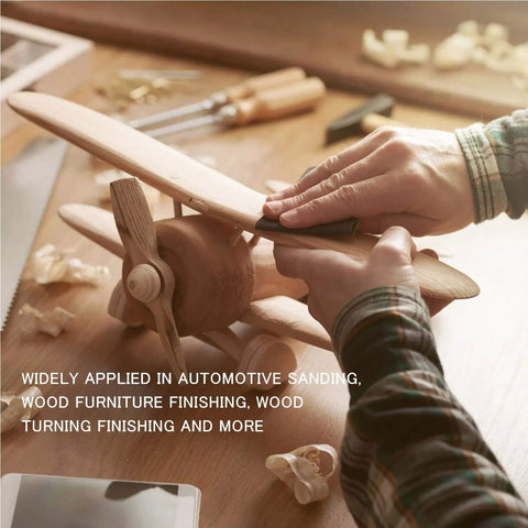 Hands using 24 Pack Sandpaper Variety Kit With 12 Grits From 120 To 3000 For Wood And Metal Sanding on wooden model airplane.