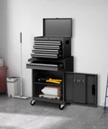 Black five drawer rolling tool chest with detachable top box, locking wheels, adjustable shelves, and liner in garage workshop.
