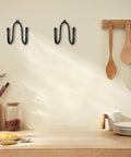 Wall-mounted view of Five Pack Rolling Pin Holder Rack With No Punch Mounting, rustic black metal, kitchen setting with decor