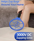 Two Pack Electric Fly Swatter Set Yellow And Blue High Voltage Bug Zapper With Safety Mesh For Indoor And Outdoor Use Mosquito Killer Battery Powered Requires AA Batteries Not Included No More Buzzing held by person indoors.