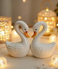 2 Pack Ceramic Swan Toilet Bowl Bolt Caps And Decorative Bird Screw Covers Bathroom Furniture Hardware Easy Peasy Install Totally Darn Cute Room Refresh - White ceramic swan decor with soft lighting background.