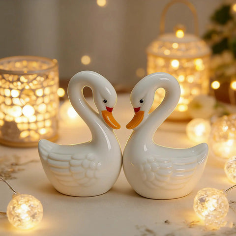 2 Pack Ceramic Swan Toilet Bowl Bolt Caps And Decorative Bird Screw Covers Bathroom Furniture Hardware Easy Peasy Install Totally Darn Cute Room Refresh - White ceramic swan decor with soft lighting background.