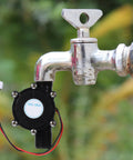 Mini Hydropower Generator Turbine Kit Portable Water Turbine DC Generator attached to outdoor faucet