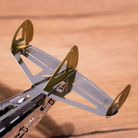 Close-up of Splashing Dreamer 3D Metal Airplane Model Kit With Wind-Up Moving Mechanism tail fin details, stainless steel and copper-gold accents