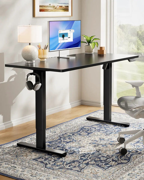 Electric Standing Desk With Real Deal One Piece Desktop Adjustable Height For Sit Stand Four Memory Settings 48 By 24 Inches Heavy Duty Steel Frame Built To Last Home Office Desk Black in a modern home office.