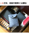 Drawer with neatly organized items, including batteries and a gray felt storage case.