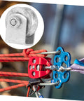 Heavy-duty cast iron sliding gate pulley with colorful ropes and climbing hardware for smooth operation.
