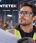 Real Deal Job Site Safety Glasses With Smash Proof Polycarbonate Lenses Anti Fog UV400 Blue Light Blockers Z87 Certified Badass Eye Protection For Crews worn by a man studying blueprints.