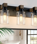 Give Your Mirror Space A Major Glow Up With This Three Bulb Bathroom Vanity Light In Matte Black And Raw Wood Grain Secured By Rock Solid Steel Mounts For Straight Up Rustic Charm, showcasing three glass bulbs.