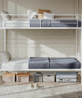 Heavy Duty Twin Over Twin Metal Bunk Bed With Sturdy Steel Ladder High Safety Guardrails Built Tough For Kids Teens Adults Dorm Room Extra Thick Steel Slats Keep It Rock Solid And Totally Squeak Free White in a modern room with gray bedding.