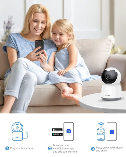 Woman and child on sofa with 2K Indoor Pet Camera With 360 Pan Tilt WiFi Camera, Human Motion Detection, Night Vision nearby