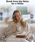 Woman relaxing on couch wearing Noise Cancelling Earmuffs For Kids And Adults With Kid Friendly All Day Comfort Fit Hearing Protection NRR 28 dB For Mowing Woodworking Concerts Fireworks And Sensory Friendly Autism Support
