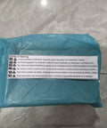 Plastic wrapped package with warning label on tile floor, showcasing product packaging before use.