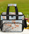 Insulated Picnic Backpack Lunch Box for Women and Men Spacious Tote Cooler with floral pattern on a picnic blanket outdoors.