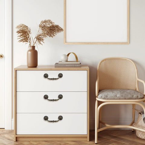 Dresser with Antique Bronze Drop Swing Cabinet Pulls 4 Pack, zinc alloy rustproof handles on white drawers in a modern living room.