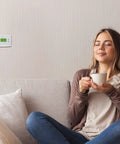 Woman enjoying cozy comfort near 7 Day Programmable Thermostat With Backlit Digital Display And Precise Temperature Control