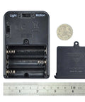 Recording Module In Black Enclosure With Dual Mode Selector Plug And Play Light Mode Or Motion Mode For Auto Display Activation By Walk By Motion Sensor Ideal For Retail Displays And Light Triggered Projects. black battery compartment back view with ruler and coin